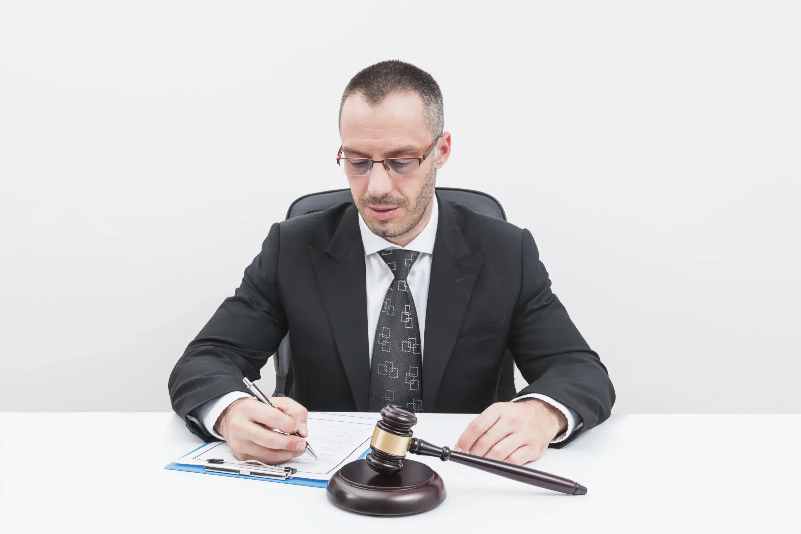 Criminal attorney reviewing legal documents at a desk with a gavel, representing legal expertise for criminal defense cases in Utah